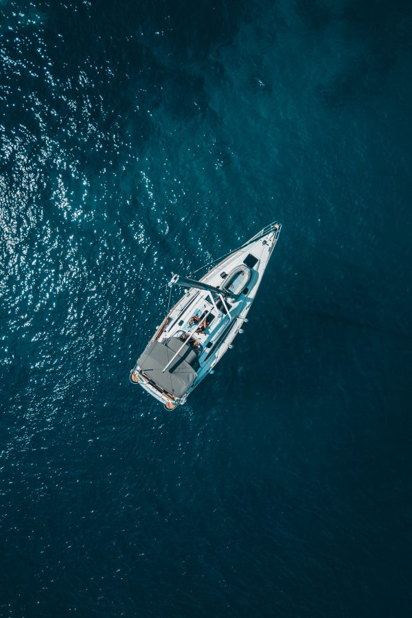 high-angle-photo-of-white-boat-on-body-of-water-1295036