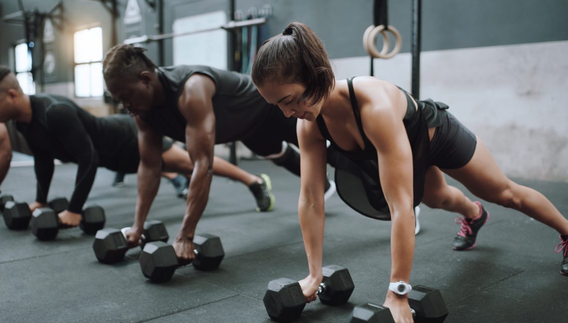 weights and plank workout with training and exercise group with strength. Diversity, people and strong challenge for body lifting and fitness of athlete friends with dumbbell for health.