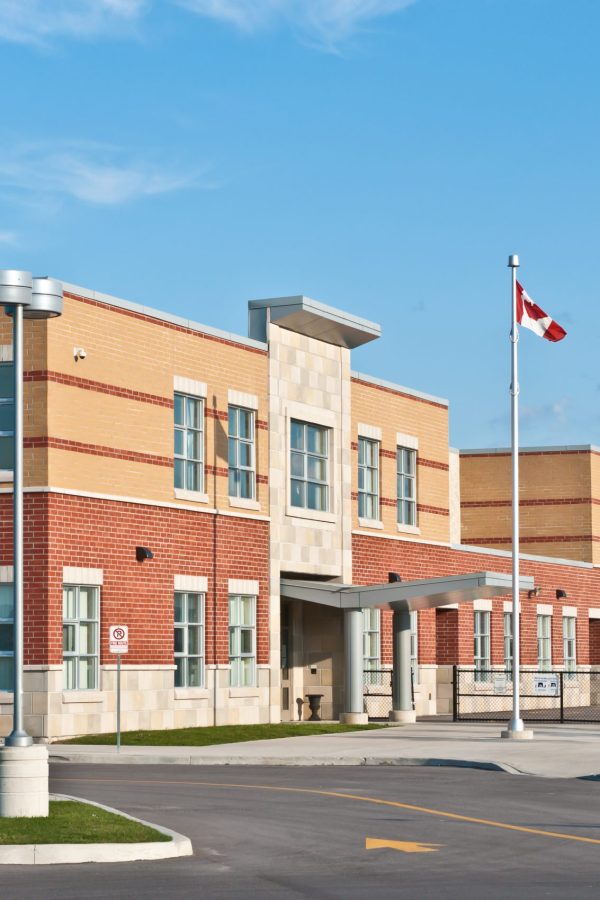 New Canadian Elementary School Building A new Canadian elementary school building with flagpole and parking lot.