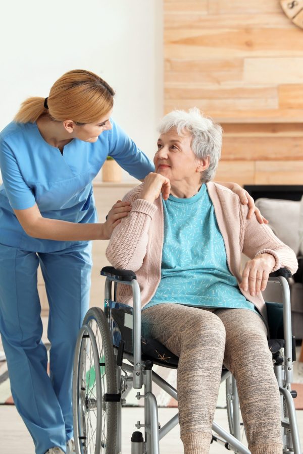 Nurses assisting elderly people at retirement home